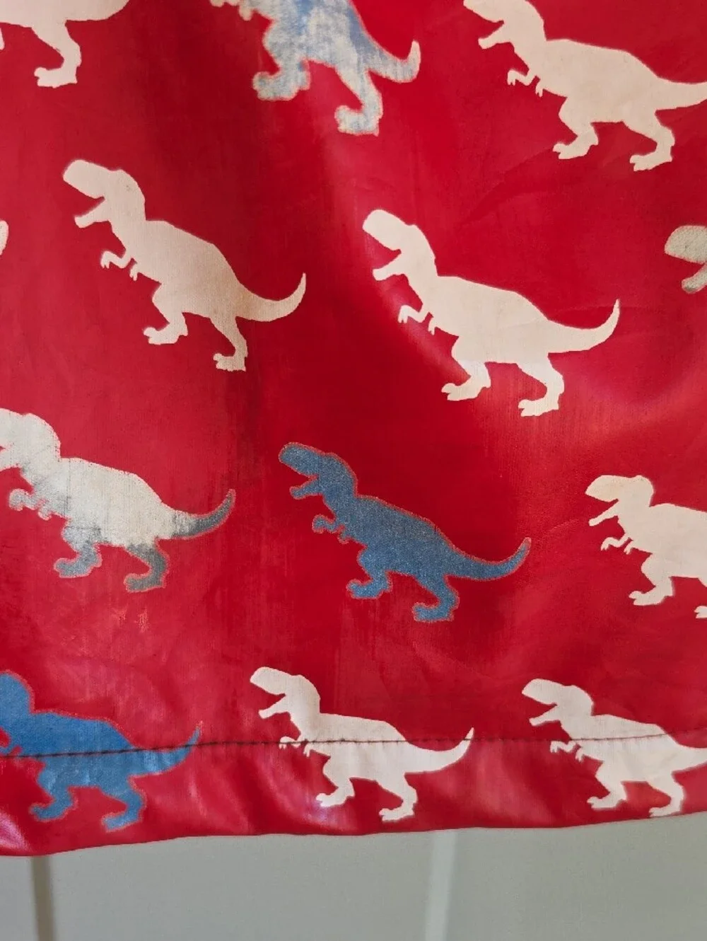 Hatley Red Raincoat with White Dinosaur Print Changes Color When Wet